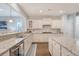 Bright kitchen features granite countertops, stainless steel appliances and an island at 1822 Grovehurst Dr, Charleston, SC 29414