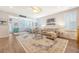 Open concept living room with fan, wood floors and great light from many windows at 1822 Grovehurst Dr, Charleston, SC 29414