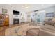 Comfortable living room with fireplace, ceiling fan, view to the kitchen and hardwood floors at 1822 Grovehurst Dr, Charleston, SC 29414