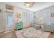 Inviting living room with wood floors, shutters, ceiling fan, and stylish blue and cream color scheme at 1822 Grovehurst Dr, Charleston, SC 29414