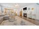 Open floorplan with wood floors, living room fireplace, and view of kitchen with barstool seating at 1822 Grovehurst Dr, Charleston, SC 29414