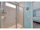 Tiled shower featuring a glass enclosure, built-in shelving, and a view of the Primary suite at 1822 Grovehurst Dr, Charleston, SC 29414