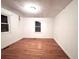 An empty bedroom featuring hardwood floors and natural light from two windows at 1871 Grimball Rd, Charleston, SC 29412