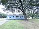 Charming single-story home with a well-maintained yard, mature trees, and a welcoming front porch at 1871 Grimball Rd, Charleston, SC 29412