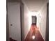 Long hallway featuring hardwood floors and access to bedrooms and other areas of the home at 1871 Grimball Rd, Charleston, SC 29412
