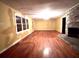 Bright living room featuring hardwood floors, a brick fireplace, and large windows for natural light at 1871 Grimball Rd, Charleston, SC 29412