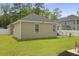 Exterior: View of a tan home featuring a well-maintained lawn and a fenced-in backyard at 201-B Mcmakin Dr, Summerville, SC 29483