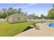 Sprawling backyard with well-manicured lawn, established trees, patio, and additional seating at 201-B Mcmakin Dr, Summerville, SC 29483