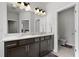 Bathroom with dual sinks, generous counter space, dark wood cabinets and an adjoining toilet room at 201-B Mcmakin Dr, Summerville, SC 29483