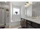 Bright bathroom featuring double sinks, a large window, soaking tub, and glass enclosed shower at 201-B Mcmakin Dr, Summerville, SC 29483