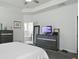 Bright main bedroom featuring neutral decor, tray ceiling, TV and ensuite bathroom at 201-B Mcmakin Dr, Summerville, SC 29483