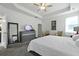 Spacious main bedroom boasts a ceiling fan, tray ceiling, a dresser and a television at 201-B Mcmakin Dr, Summerville, SC 29483