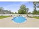 Inviting in-ground pool surrounded by concrete patio, lounge chairs, and landscaped yard at 201-B Mcmakin Dr, Summerville, SC 29483