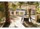 Inviting backyard with a patio table and seating under an umbrella, surrounded by trees at 203 Weiters St, Walterboro, SC 29488