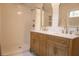 Modern bathroom with walk-in shower, double vanity, marble countertop, and wood cabinets at 203 Weiters St, Walterboro, SC 29488