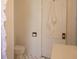 Cozy bathroom with white patterned floor tiles and matching white walls, door, and vanity at 203 Weiters St, Walterboro, SC 29488