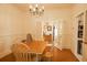 Inviting dining room with a wood table, chairs, chandelier, and view to a living area at 203 Weiters St, Walterboro, SC 29488
