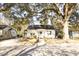 Inviting white home with a classic design, surrounded by mature trees and a well-maintained yard at 203 Weiters St, Walterboro, SC 29488