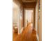 Hallway view with hardwood floors and doorways leading to other rooms at 203 Weiters St, Walterboro, SC 29488