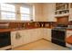 Functional kitchen with white cabinets, black appliances, and plaid backsplash at 203 Weiters St, Walterboro, SC 29488