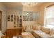 Bright living room featuring hardwood floors, a crystal chandelier, and decorative shelving at 203 Weiters St, Walterboro, SC 29488