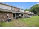 Exterior view of the backyard with a screened-in porch, brick facade and yard at 2045 Rondo St # B, Charleston, SC 29414