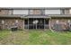Exterior view of the backyard with a screened-in porch and brick facade at 2045 Rondo St # B, Charleston, SC 29414