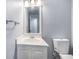Bathroom with white vanity, faucet, mirror and light fixture; and toilet at 2045 Rondo St # B, Charleston, SC 29414