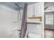 Bathroom with white tub and shower, shower curtain, shower head, shelves and cabinets at 2045 Rondo St # B, Charleston, SC 29414