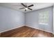 Bedroom with wood flooring, ceiling fan, window and light blue walls at 2045 Rondo St # B, Charleston, SC 29414