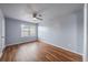 Bedroom with wood flooring, ceiling fan, window and a closed door at 2045 Rondo St # B, Charleston, SC 29414