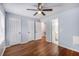 Bedroom with wood floors, ceiling fan and view to ensuite bathroom at 2045 Rondo St # B, Charleston, SC 29414