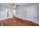 Bedroom with wood flooring, ceiling fan, and view into the bathroom at 2045 Rondo St # B, Charleston, SC 29414