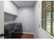 Dedicated laundry area with modern washer and dryer, plus storage cabinets at 2045 Rondo St # B, Charleston, SC 29414