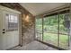 View of brick enclosed porch with access door and large screened windows at 2045 Rondo St # B, Charleston, SC 29414