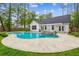 Backyard oasis with a sparkling pool, integrated spa, and lush greenery, perfect for relaxation and entertainment at 206 Almond Ct, Summerville, SC 29483