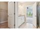 Bathroom with granite counters, white cabinets, and a view into an adjoining room with a ceiling fan at 206 Almond Ct, Summerville, SC 29483