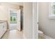 Bathroom with granite counters, white cabinets, a tile floor, and a partial view of the glass enclosed shower at 206 Almond Ct, Summerville, SC 29483