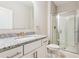 Clean bathroom with granite counters, tile floor, glass shower, and modern fixtures at 206 Almond Ct, Summerville, SC 29483