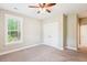 Bright bedroom features a ceiling fan, a large window with blinds, and a double-door closet at 206 Almond Ct, Summerville, SC 29483