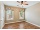 Bedroom with hardwood floors, ceiling fan, and windows with custom valances at 206 Almond Ct, Summerville, SC 29483