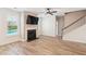 Bright living room with hardwood floors, fireplace, mounted TV, and view of the pool at 206 Almond Ct, Summerville, SC 29483