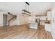 Open living space with hardwood floors, a modern light fixture, stairs, and a kitchen with white cabinets at 206 Almond Ct, Summerville, SC 29483