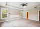 Spacious carpeted main bedroom featuring tray ceiling, fan, large window with view, and wall decorations at 206 Almond Ct, Summerville, SC 29483