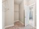 Walk-in closet with wire shelving adjacent to an ensuite bathroom featuring a glass enclosed shower at 206 Almond Ct, Summerville, SC 29483