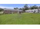 Backyard features a well-maintained lawn, a brick home with a patio, and a spacious tent for outdoor entertaining at 212 Columbia Dr, Ladson, SC 29456