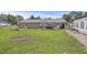 Well-maintained backyard featuring a brick home, a sprawling lawn, and a large tent for events or storage at 212 Columbia Dr, Ladson, SC 29456
