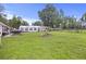 Expansive backyard featuring lush green grass, mature trees, a large tent, and space for outdoor activities at 212 Columbia Dr, Ladson, SC 29456