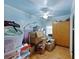 Bedroom filled with boxes and personal items, featuring blue walls, a ceiling fan, and natural light at 212 Columbia Dr, Ladson, SC 29456