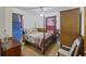 Bedroom with wooden floors and paneling, a ceiling fan and a view to the side yard at 212 Columbia Dr, Ladson, SC 29456